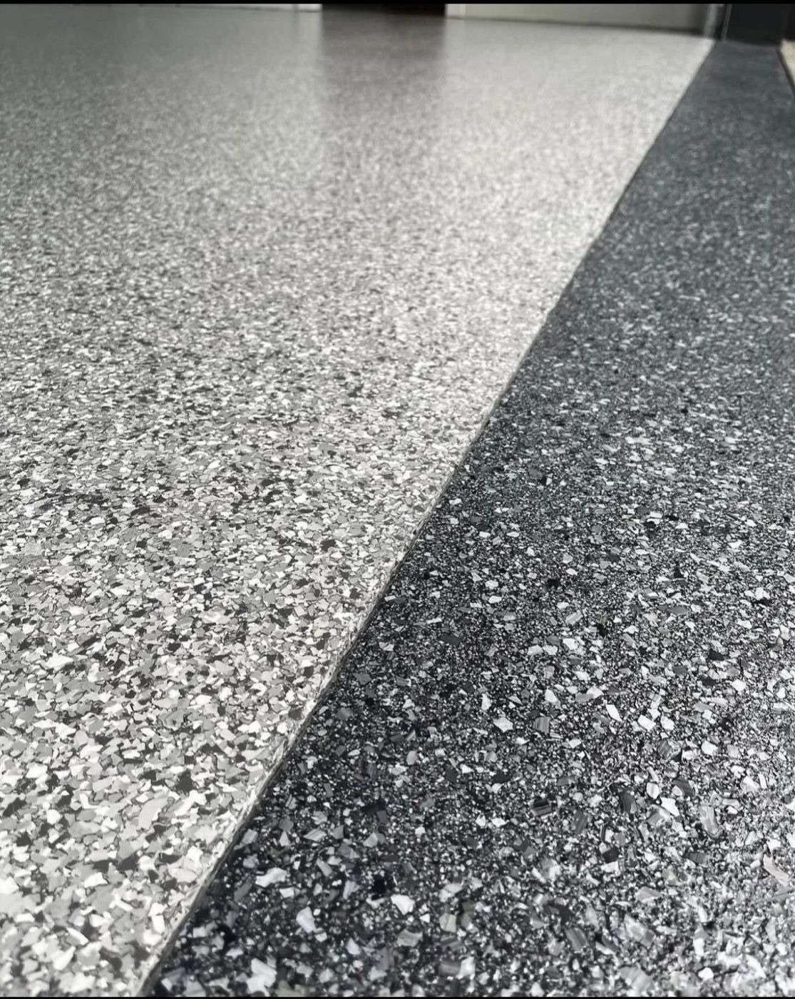 Close-up of two epoxy flake colors meeting at a clean line - real BM Epoxy install in Aurora, Colorado